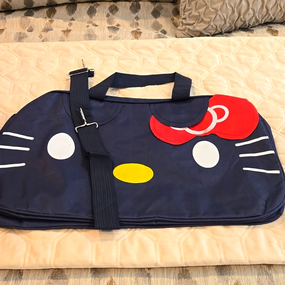 Hello Kitty weekender travel duffle bag with crossbody strap. Navy Blue